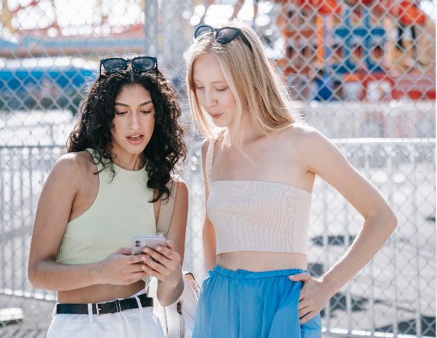 Two riders looking up a vehicle on their phone