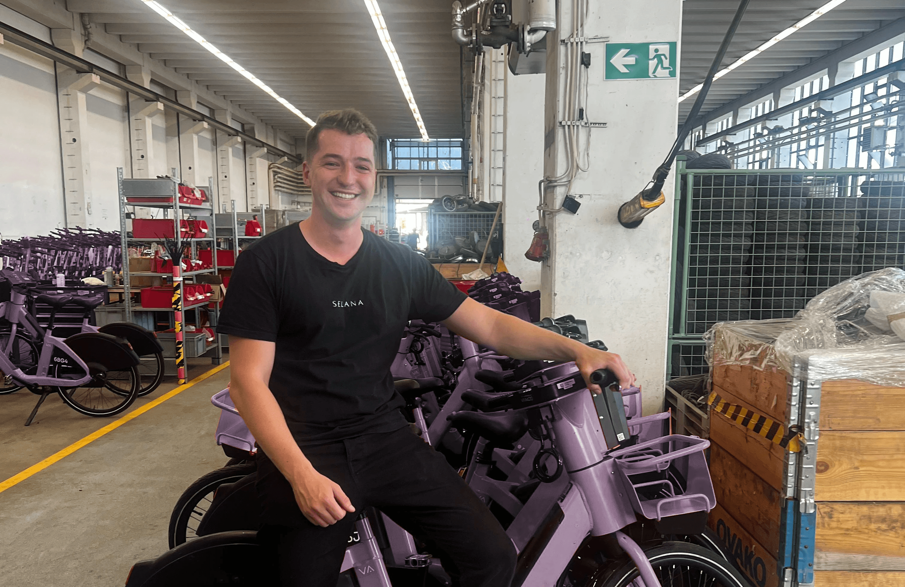 A Fleetser team member with e-bikes in the warehouse